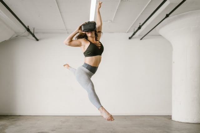 A woman dancing wearing VR goggles 